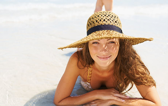 Beautiful woman in swim wear by the ocean